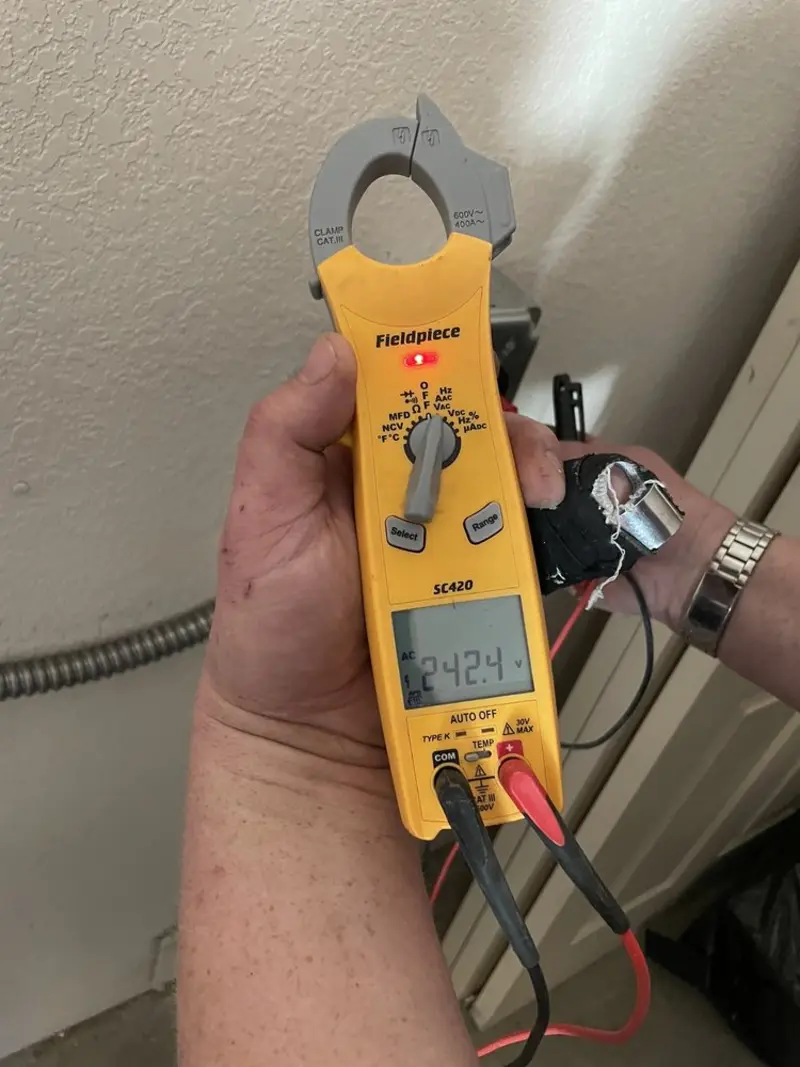 Voltage testing with clamp meter during Outlet Installation in Jordan